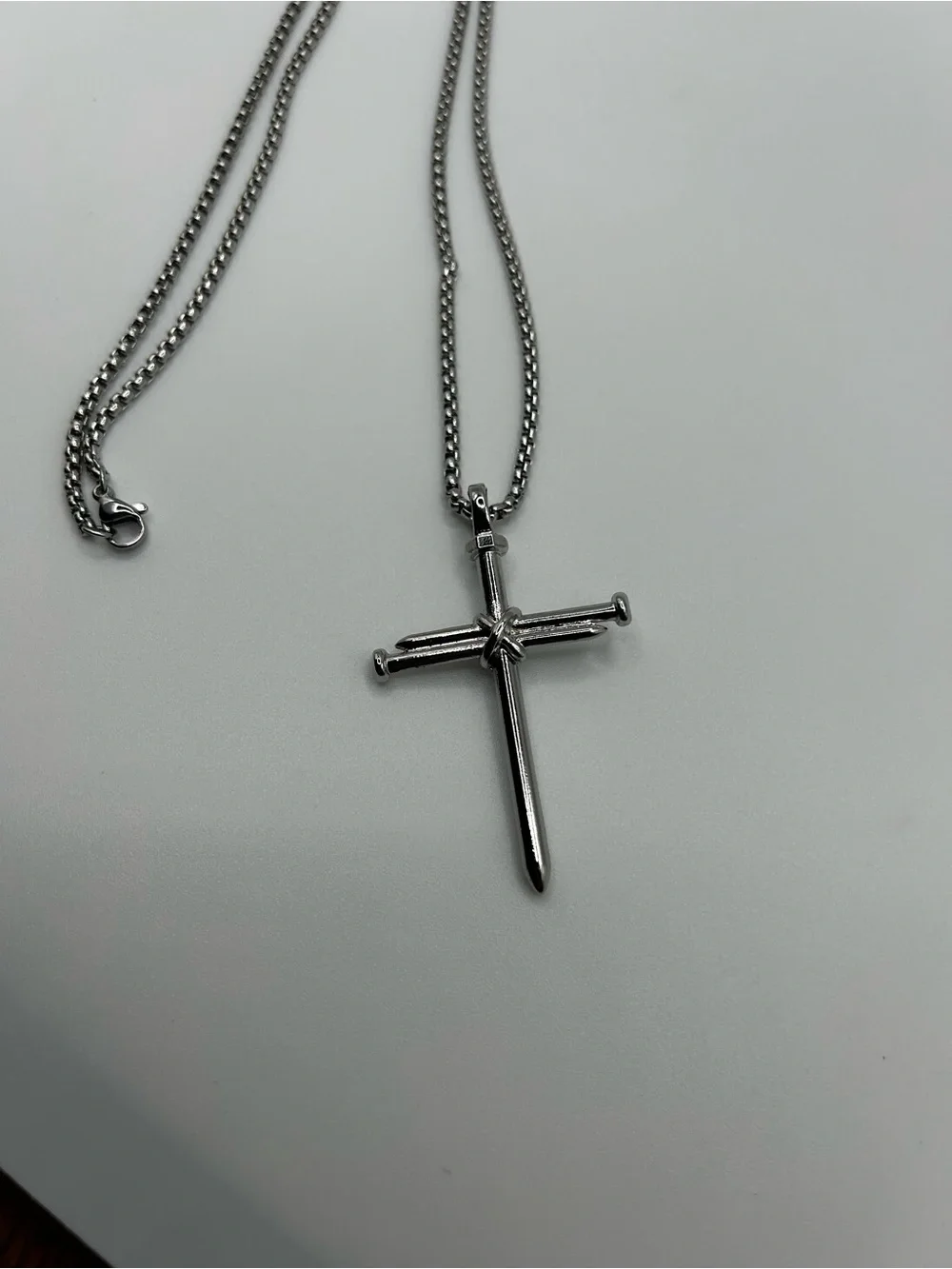 Stainless steel cross pendant necklace with textured detail